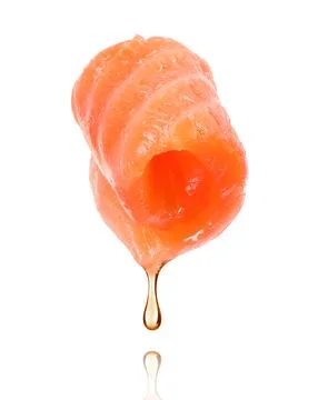 Juicy slice of red fish with falling fat drop, isolated on white background Stock Photos