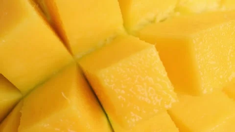 Juicy sliced ​​mango rotates close-up. Organic tropical fruit, food Stock Footage 340410185