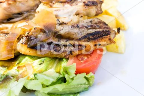 Juicy steak beef meat with tomato and potatoes Stock Photos