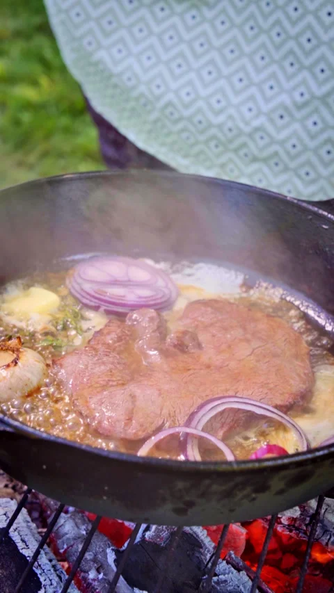 Juicy steak in being cooked in a cast iron pan on the grill. Stock Footage 315269254