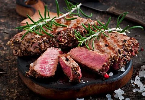 Juicy steak medium rare beef with spices Stock Photos