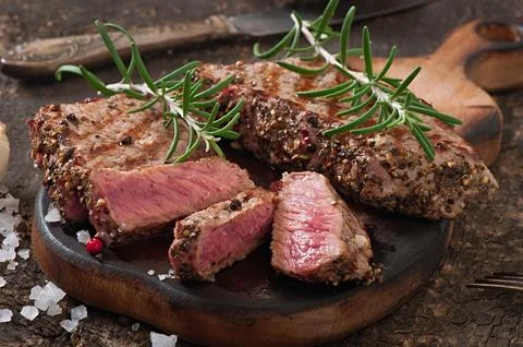 Juicy steak medium rare beef with spices Stock Photos