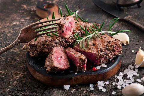 Juicy steak medium rare beef with spices Fotos de archivo