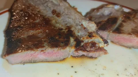 A juicy steak in the plate 動画素材 241691705