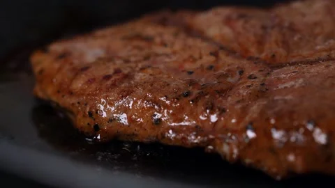 A juicy steak is roasting in a pan Stock Footage 152047421