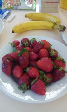 Juicy strawberries, ripe bananas - and a snack. Stock Photos