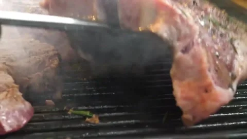 Juicy T-Bone Steak Grilling on BBQ with Rosemary and Smoke Stock Footage 338213138