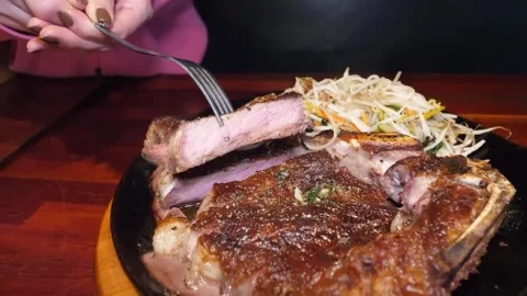 Juicy T-Bone Steak Sizzling on a Hot Plate, Ready to Eat Video stock 332817545