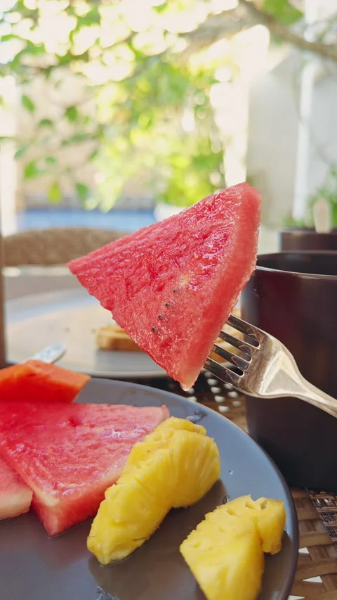 Juicy Watermelon Slice Held On Fork Above Tropical Breakfast Table Near Resort P Stock Footage 336812914