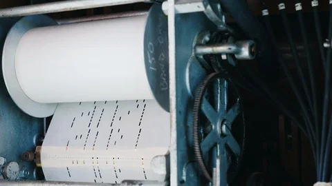 An  jukebox mechanism where the melody is programmed on a paper punch card Stock Footage 117669450