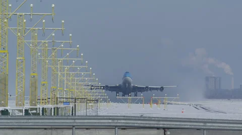Jumbo filmed head on during take off from a snowy runway Stock Footage 46000314