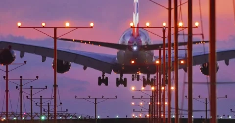 Jumbo jet airplane plane landing in airport in Los Angeles at sunset. 4K UHD Stock Footage 42723717