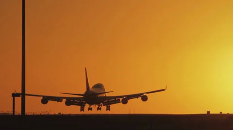 Jumbo landing at sunset Stock Footage 38496754