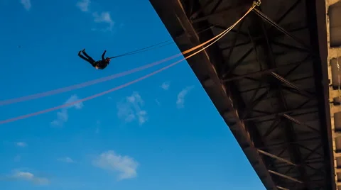 Jump off a bridge on the background of blue sky Stock Footage 46984038
