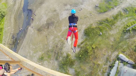 Jump from the bridge facing forward with side turn Stock Footage 53350084