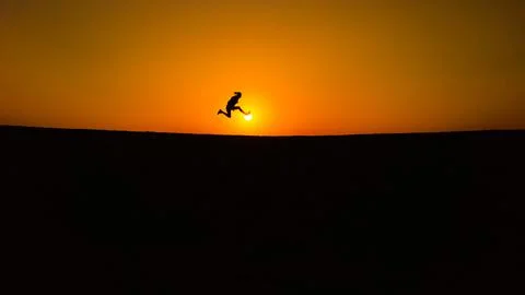 Jump in desert during sunset Stock Photos