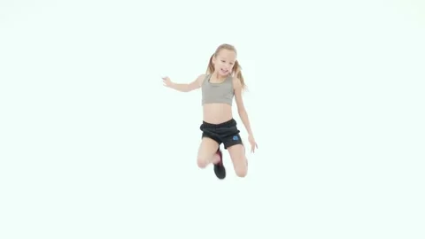 Jump for fun. Adorable little elementary girl in sportswear smiling at camera Stock Footage 149246539