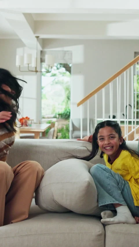 Jump, laughing and sofa with interracial family in home together for playful Stock Footage 338188732