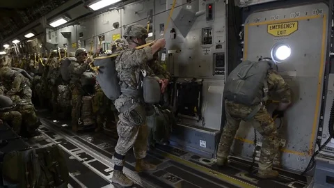 Jump master opening hatch of C-17 globemaster Stock Footage 90939473