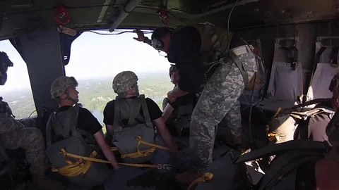 Jump master preparing parachutists to jump from helicopter Stock Footage 90117034