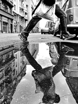 Jump over the puddle Stock Photos