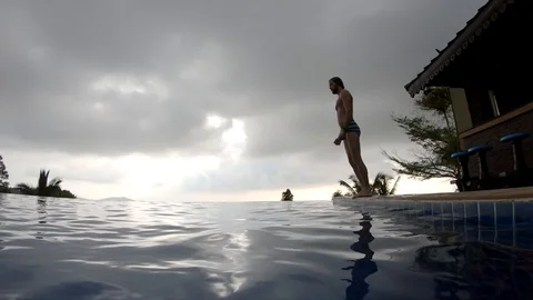 Jump into the pool summer time slowmotion in thailand Stock Footage 120580498