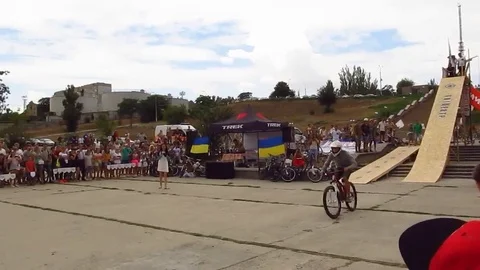 Jump into the river from a springboard on a bicycle Stock Footage 103436035