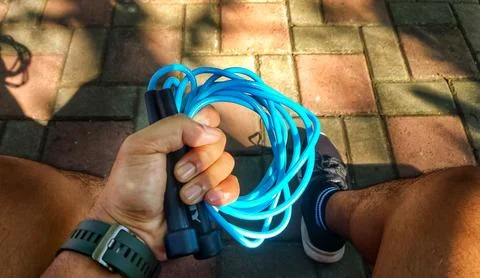 Jump rope on a background of trees in the park Stock Photos