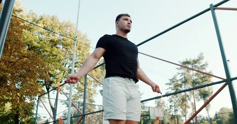 Jump Rope Training Session in the Beautiful Autumn Park Filled with Colorful Stock Footage 317837884