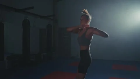 Jump rope workout session in a martial arts studio at night for improving Stock Footage 284413530