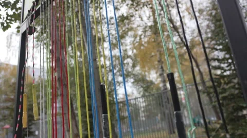 Jump ropes dangle from sturdy park stand awaiting users Видео 309755242