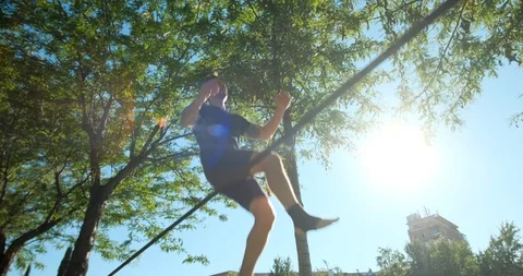 Jump On Slackline With Young Man Performing Acrobatics Show Stock Footage 111233238