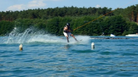 Jump With Wake-board In Cable Park. Wakeboarder surfing athlete water Slow Mo Vidéo 97069390