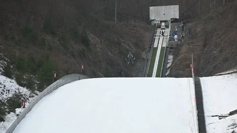 Jumper flying over ski jump ramp Stock Footage 151210101