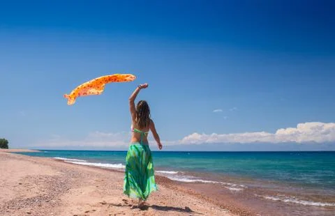 Jumping and dancing happy girl on the beach, fit sporty healthy sexy body in Stock Photos