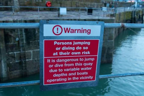 Jumping and diving from the quay warning sign Stock Photos