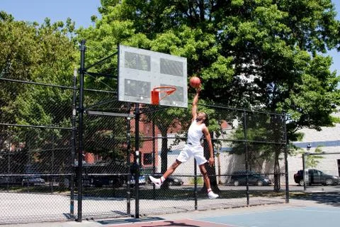 Jumping basketball player Stock Photos