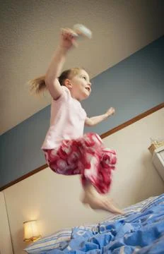 Jumping On The Bed Stock Photos