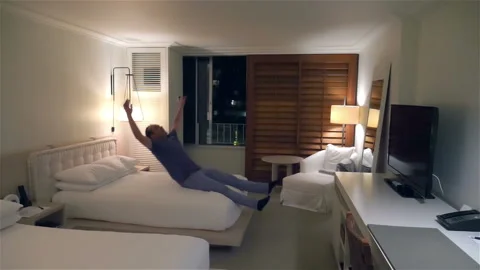 Jumping on the bed in slow motion 180fps Stock Footage 114060545