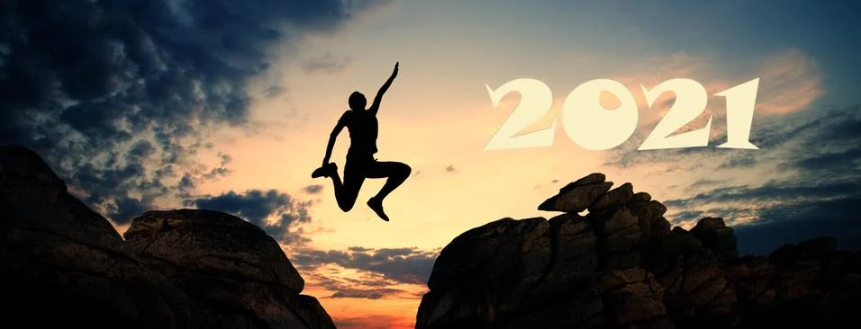 Jumping between cliffs at sunset goals in new year Stock Photos