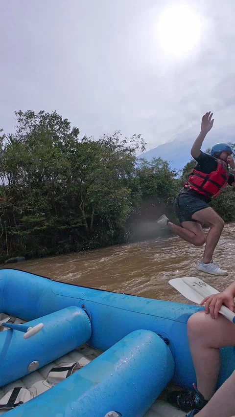 Jumping From a Blue Inflatable Raft. 動画素材 329528945