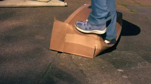 Jumping on cardboard box to squash Stock-Footage 332360013
