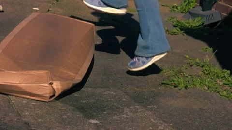Jumping on cardboard box to squash Stock Footage 333264901