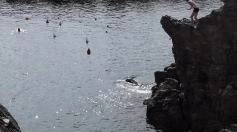 Jumping off Cliff into Mediterranean Stock Footage 32136107