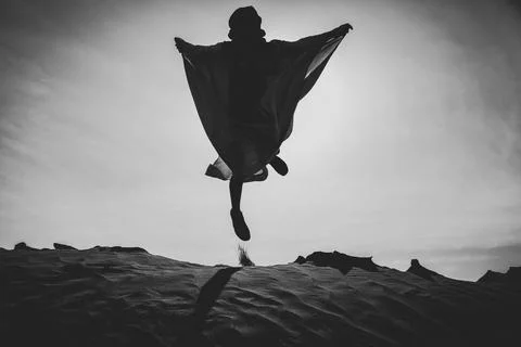 Jumping In The Desert Celebrating Her Freedom Stock Photos