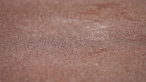 Jumping grains of rust on shaking old brown iron surface close up. Stock Footage 96884226