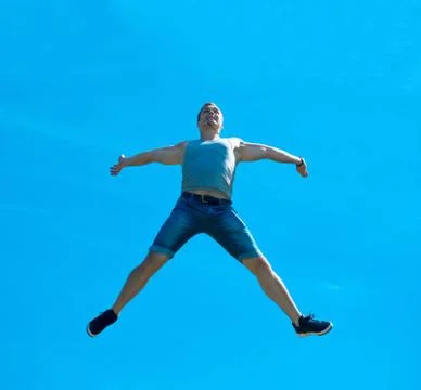 Jumping up guy. Background blue sky. Stock Photos
