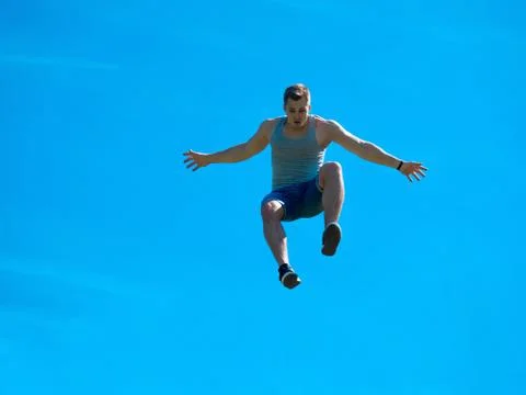 Jumping up guy. Background blue sky. Stock Photos