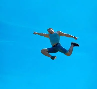 Jumping up guy. Background blue sky. Stock-Fotos