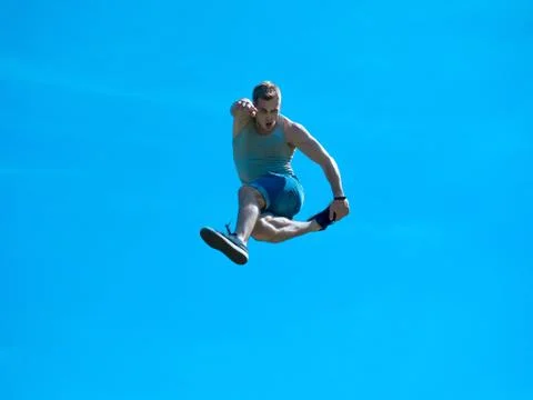 Jumping up guy. Background blue sky. Stock-Fotos